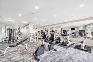 A gym with various exercise equipment, including treadmills and weight machines, and a carpeted floor. - The Patricia Grand 0628 (Myrtle Beach)