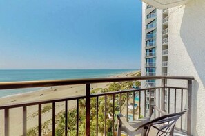 A balcony with a view of a beach and a pool area. - The Patricia Grand 0628 (Myrtle Beach)