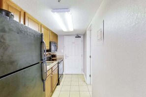 A kitchen with a refrigerator, microwave, and sink. - The Patricia Grand 0728 (Myrtle Beach)