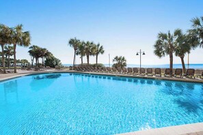 A clear blue pool with lounge chairs and palm trees. - The Patricia Grand 0728 (Myrtle Beach)