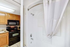 A bathroom with a shower, a toilet, and a sink. - The Patricia Grand 0728 (Myrtle Beach)