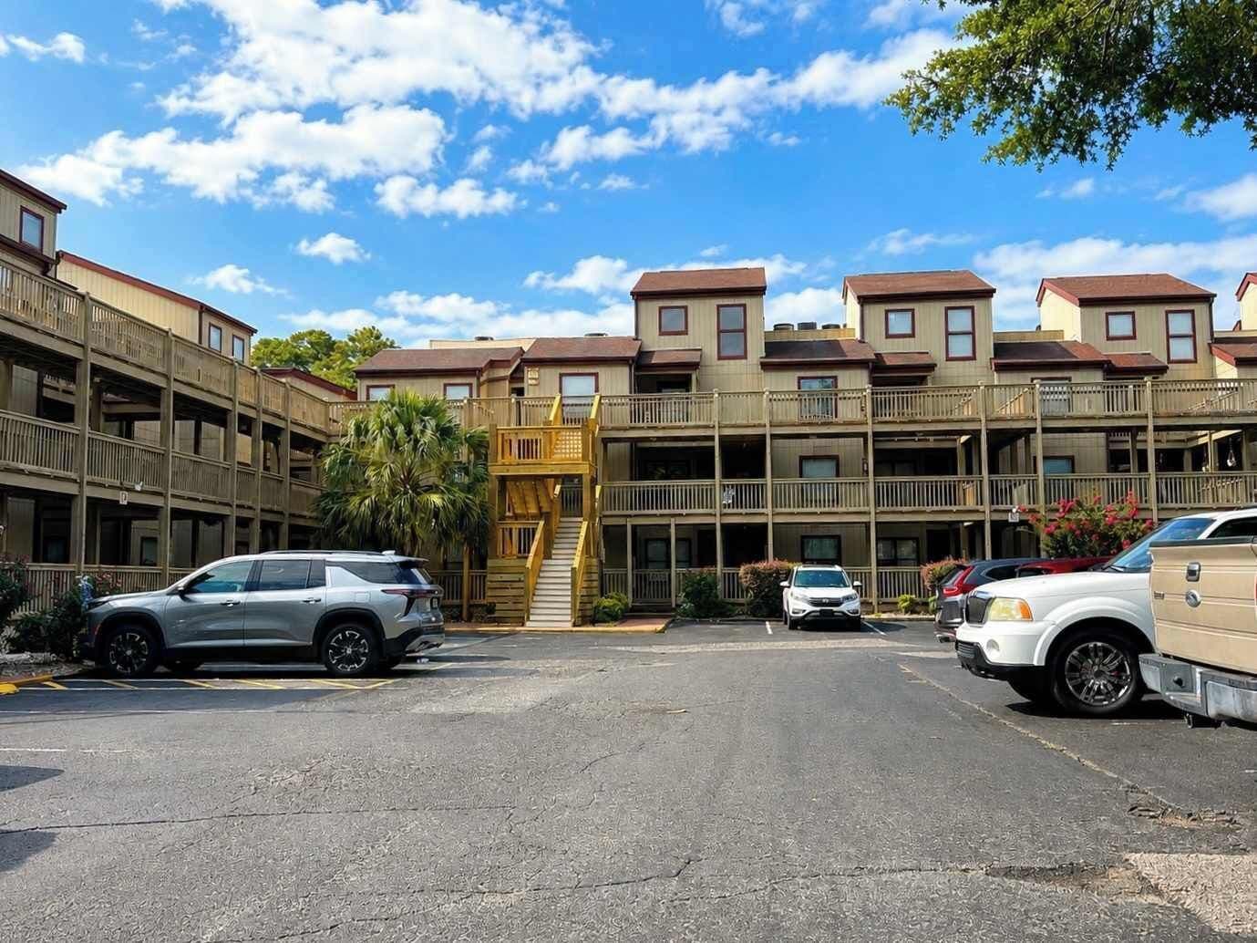 A multi-story parking garage with vehicles parked.