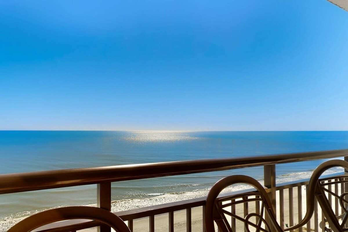 A balcony with a view of the ocean.