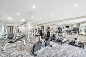 A modern gym with various cardio and strength training equipment, including treadmills, stationary bikes, and weight machines. - The Patricia Grand 1428 (Myrtle Beach)