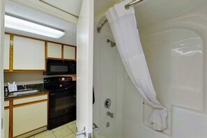 A bathroom with a bathtub, a shower, and a toilet. - The Patricia Grand 1428 (Myrtle Beach)