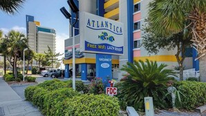 A hotel named ATLANTICA with a sign indicating free WiFi and a lazy river. - Lighthouse Corner Getaway (Myrtle Beach)