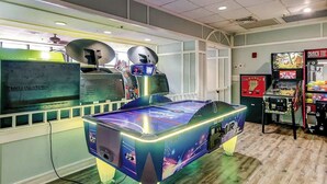 A room with a pool table, a pinball machine, and a jukebox. - Golden Mile Condo Retreat (Myrtle Beach)
