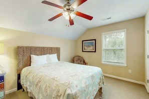 A bedroom with a bed, a ceiling fan, a window with blinds, and a chair. - 324 Snorkel Way Condo (Myrtle Beach)