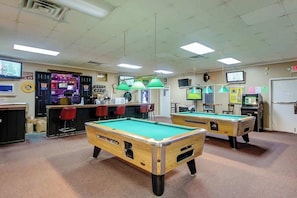 A pool hall with multiple pool tables, a bar area, and a billiard room. - Arcadian Dunes 12-246 (Myrtle Beach)