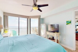A hotel room with a bed, a television, a desk, and a balcony with a view. - Beach Club III 9-C Unit (North Myrtle Beach)