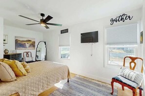 A bedroom with a bed, a chair, a television, and a window. - Coastal Gem of Murrells Inlet (Murrells Inlet)