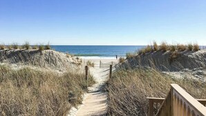 A sandy beach path leading to the ocean with a wooden fence on one side. - Sea Winds PH4 Unit Condo (North Myrtle Beach)