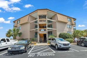 A multi-story building with a flat roof, balconies, and a parking area marked 'NO PARKING.' - A Place at the Beach III 2-I (Myrtle Beach)
