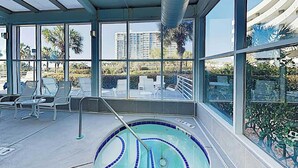 A pool area with a view of palm trees and buildings. - North Hampton Oceanfront 1501 (Myrtle Beach)