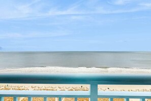 A beach view with a clear sky, a calm sea, and a sandy shore. - Roxanne Towers Unit 1101 (Myrtle Beach)