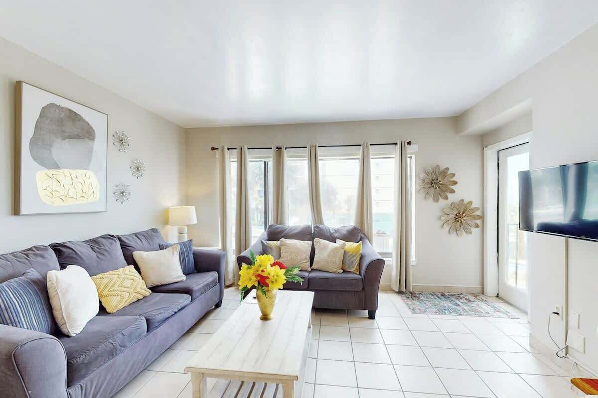 A living room with two sofas, a coffee table, and a TV.