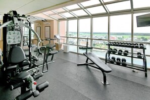 A gym with exercise equipment, a bench, and a rack of dumbbells. - Prince Resort Unit 1708 (North Myrtle Beach)