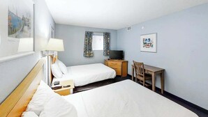 A hotel room with two beds, a desk, a chair, a television, and artwork on the walls. - Bay Watch Resort 0808 (North Myrtle Beach)