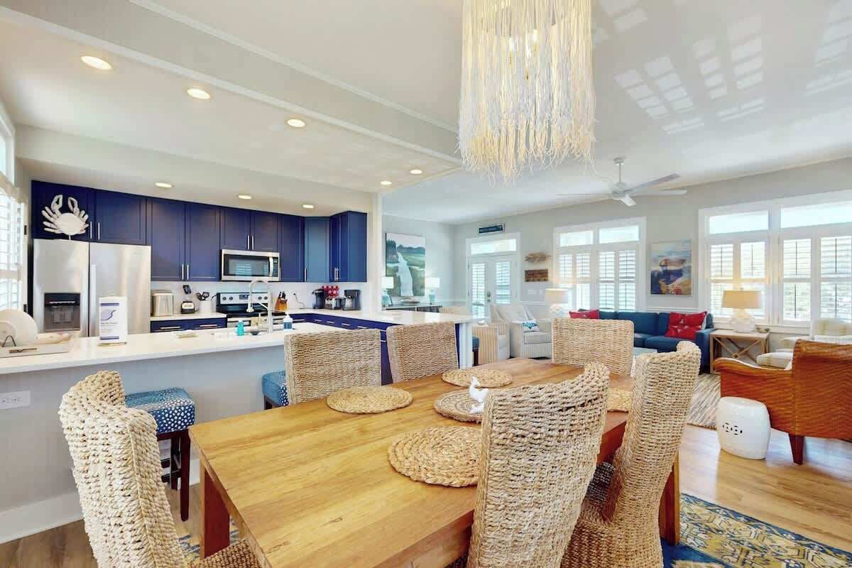 Een moderne keuken met donkerblauwe kastjes, een roestvrijstalen koelkast en een magnetron.