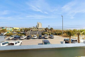 A parking lot with multiple cars and a building in the background. - Shore Breeze Unit 2 Condo (North Myrtle Beach)