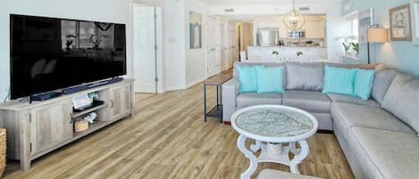 A living room with a television, sofa, and coffee table.