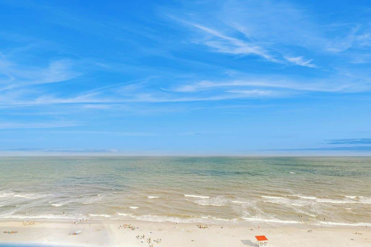 A beach with clear skies and calm waters.