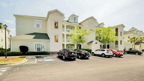 A multi-story residential building with a parking lot. - 1017 World Tour Unit 204 (Myrtle Beach)