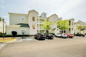 A multi-story residential building with a parking lot. - 1017 World Tour Unit 204 (Myrtle Beach)