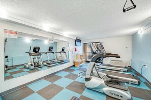 A gym with treadmills, elliptical machines, and a mirrored wall. - Carolinian Beach Resort 1734 (Myrtle Beach)