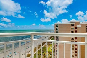 A beachfront hotel with balconies overlooking the ocean and beach. - Carolinian Beach Resort 1734 (Myrtle Beach)