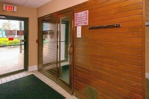 An exit door with a sign indicating no one under 18 allowed without supervision. - Palace Resort Unit 813 (Myrtle Beach)