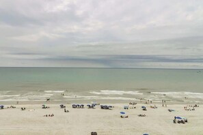 A beach with umbrellas and people. - Bahama Sands Unit 0706 (North Myrtle Beach)