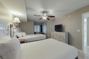 A hotel room with two beds, a ceiling fan, a television, and a dresser. - Bahama Sands Unit 0706 (North Myrtle Beach)