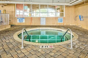 A small indoor pool with a 3 FT depth sign, surrounded by a tiled floor, and warning signs about no lifeguard and shallow water. - Bahama Sands Unit 0706 (North Myrtle Beach)