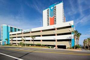 A multi-story parking garage with a sign indicating 'EXIT ONLY' on the lower level. - Palace Resort Unit 1210 (Myrtle Beach)