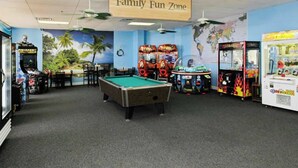 A Family Fun Zone with a pool table, arcade games, and a world map mural. - Myrtle Beach Resort B-349 (Myrtle Beach)