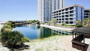 A hotel with multiple floors, a pool, and a beach area. - Myrtle Beach Resort B-349 (Myrtle Beach)