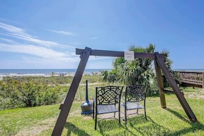 A beachside seating area with a sign indicating a smoking area, overlooking the ocean. - Atlantica Resort PH51 (Myrtle Beach)