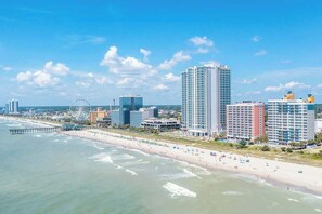 A coastal cityscape with a beachfront, high-rise buildings, and a pier. - Atlantica Resort PH51 (Myrtle Beach)