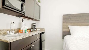 A compact kitchen with a microwave, sink, and coffee maker. - Landmark Resort 1208 (Myrtle Beach)