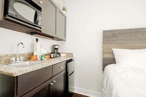 A compact kitchen with a microwave, sink, and coffee maker. - Landmark Resort 1208 (Myrtle Beach)