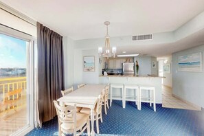 A hotel room with a dining area, a kitchenette, and a large window with a view. - Bay Watch Resort 0640 (North Myrtle Beach)