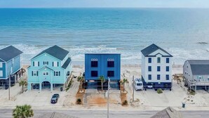 A beachfront property with three houses, a parking area, and a view of the ocean. - Blue Wave Beach Retreat (Murrells Inlet)