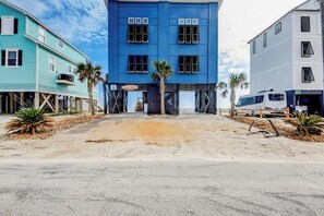 A beachfront property with a blue building, a white building, and a parked RV. - Blue Wave Beach Retreat (Murrells Inlet)