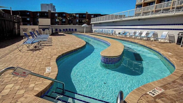 A pool area with lounge chairs, a pool sign, and a 3ft depth marker. - Sands Ocean Club 1101 Fruit Cakes (Myrtle Beach)
