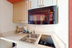 A kitchen with a built-in microwave, a coffee maker, and a sink. - Sands Ocean Club 1101 Fruit Cakes (Myrtle Beach)