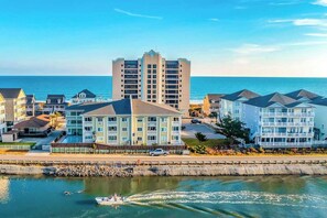 A coastal hotel with multiple buildings, a marina, and a view of the sea. - Cherry Grove Pelican's Watch (North Myrtle Beach)