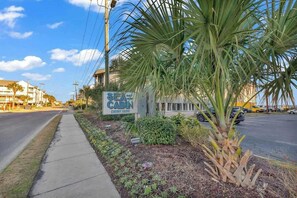 A sign for 'SEA CABIN' with a view of a street and buildings in the background. - Sea Cabin Unit 117 Condo (North Myrtle Beach)