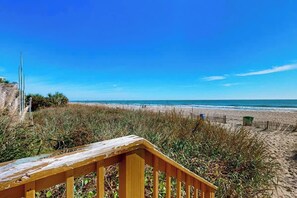 A wooden staircase leading to a beach with a clear sky. - Sand Dunes Resort 910 (Myrtle Beach)