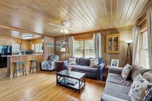 A cozy cabin interior with a kitchen, dining area, and living room. - The Little Brick Cottage (Murrells Inlet)